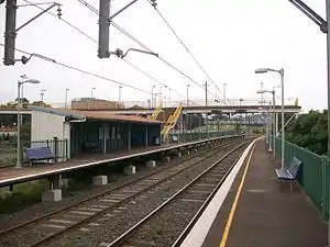 Lysaghts railway station, in Australia, with two side platforms, and a footbridge connecting them.