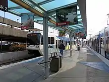 The platform of Portland International Airport station; a two-car train awaits passengers to board with it doors open
