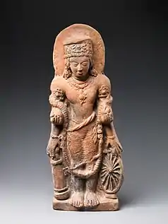 A statue of Vishnu Caturanana ("Four-Armed"), using the attributes of Vāsudeva, with the addition of an aureole around the head (5th century CE).