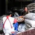 Workers cleaning dried anchovies at a market in Mae Sot, Thailand