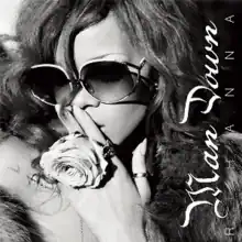 A black and white image of Rihanna wearing oversized sunglasses with "Man Down" written vertically on the right hand side