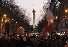 Place de la République statue column with large French flag