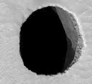 HiRISE image of Mars hole "Jeanne", about 150 meters (492 feet) across and at least 178 meters (584 feet) deep.