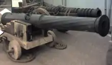 Two large metal cannon of differing designs, one in front of the other