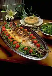Image 4Masghouf fish, one of Iraq's national dishes, a Mesopotamian cuisine dating back to ancient times, typically fish caught from the rivers of Euphrates and Tigris, and grilled near the river bed (from Culture of Iraq)