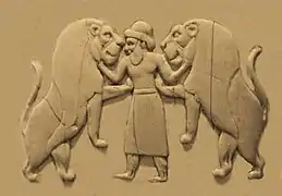 Master of animals, wearing a long skirt and trousers, as well as a brimmed hat (Back, 1st register).