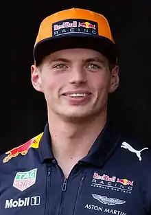 A young man wearing an orange hat.
