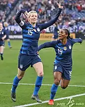 Rapinoe celebrates a goal with teammate Crystal Dunn, 2019