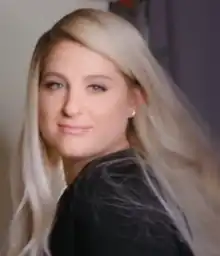 Meghan Trainor, a woman, smiling and looking towards the screen