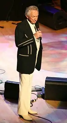 Country music singer Mel Tillis, performing on a stage.