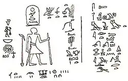 Drawing of a rock inscription showing a man standing and facing hieroglyphsStrudwick 2005, pp.&nbsp;133–134.