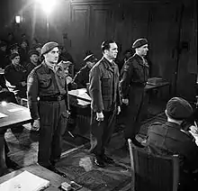 Meyer in court, standing between two guards