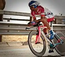 A cyclist competing on specialised time trial machinery