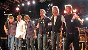 Mike + The Mechanics in 2012L-R: Ben Stone, Andrew Roachford, Tim Howar, Luke Juby, Mike Rutherford and Anthony Drennan