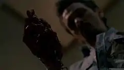 A man holds his beating heart.