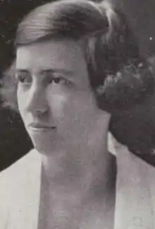 A young white woman with bobbed hair parted on the side and curled at the ends