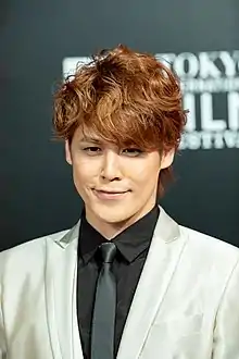 Photograph of Mamoru Miyano smiling at the camera