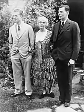 An elderly Lou Henry Hoover stands between her two adult sons