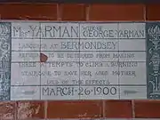 A tablet formed of six standard sized tiles, bordered by green flowers in the style of the Arts and Crafts movement