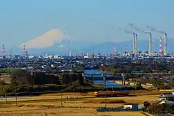 The Keiyō Belt, one of Japan's largest industrial complexes, spans the eight cities of Chiba Prefecture. Mount Fuji appears on the horizon