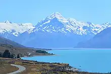 A large mountain with a lake in the foreground