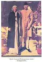 Muhammad Ali Jinnah (right), standing with his sister Fatima Jinnah (left), Leading member of Pakistan Movement. Muhammad Ali Jinnah is wearing a Sherwani and Fatima Jinnah is also wearing a female Sherwani.