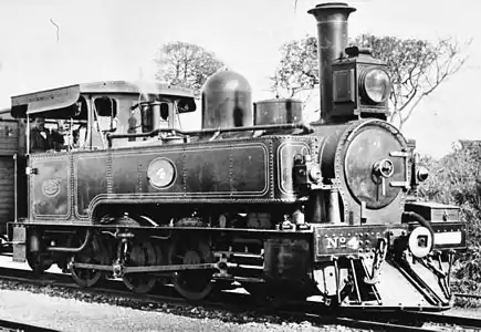No. 4 with Ramsbottom safety valves, the vacuum brake ejector exhaust pipe feeding into the extended smokebox, and a brass-capped chimney