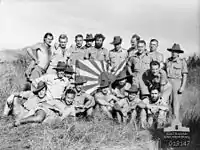 Image 22New Guinea Volunteer Rifles with captured Japanese flag, 1942 (from History of Papua New Guinea)