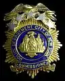 A modified version of the shield and supporters on the badge of the city police commissioner