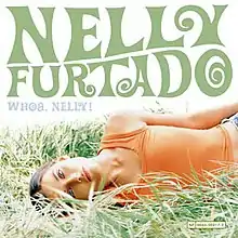 On a white background, Nelly Furtado lies on the grass, looking at the screen. "Nelly Furtado" is written in forest green capital letters, and "Whoa, Nelly!" in smaller, light-blue capital letters.