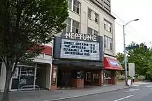 A brick building with a marquee listing upcoming performers