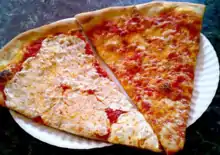 Slices of traditional New York–style pizza on right, with fresh instead of dried mozzarella cheese on left