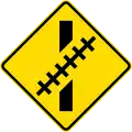 (W15-8.2/PW-60.1) Railway crossing ahead at an oblique angle