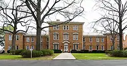 The facade of a historic, brick campus building