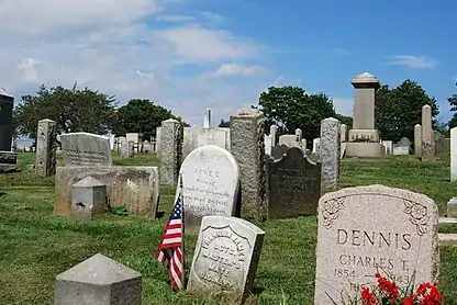 Tombstones (funerary stelae) at the Common Burying Ground and Island Cemetery, Newport, Rhode Island. Typical inscriptions include the names of the deceased interred under the stones. Ca. 18th century and later.
