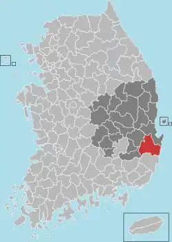 A region on an east coast is divided into 23 districts, with the southern coastal district highlighted.