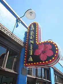 Restaurant sign mounted to the exterior of a blue building