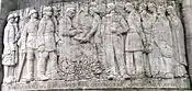 The relief on the Noyon monument aux mort which records the presentation to Noyon on 10 July 1920 of the Légion d'honneur and the Croix de guerre in recognition of the suffering and fortitude of the citizens of Noyon during the German occupation
