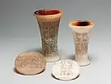 Two vases and lids covered with hieroglyphic inscriptions
