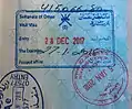 Omani visa on arrival issued at Muscat International Airport. The blue rectangular stamp represents the visa and the entry stamp. The round, red stamp is the exit stamp issued at Al Wajajah land border. The blue stamp at the left corner issued at Emirati side of Al Wajajah