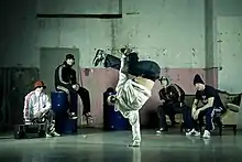 A hip hop dance crew watching as someone breaks