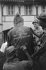 Comrades had drawn Chad together with the statement "What no women", the head of Donald Duck and the word "Jampie" on the back of a rain jacket of a Dutch soldier, 1948