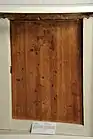 Wooden door set into modern gallery display