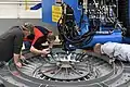 Factory workers welding the pressure vessel of the EM-2 Orion