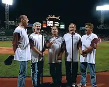 Orleans, singing the national anthem at Fenway Park in July 2006. Left to right: Charlie Morgan, Lance Hoppen, Larry Hoppen, Dennis "Fly" Amero, Lane Hoppen.