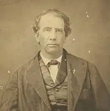 The article's subject facing directly on to the camera, pictured from the torso up.