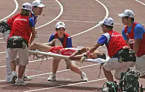 Japanese athlete is carried away after the 50&nbsp;km walk.