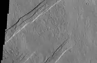 Oti Fossae, as seen by THEMIS.  These parallel graben are found on the northeastern side of Arsia Mons; they are in line with the NE/SW trend of the three volcanoes in Tharsis.