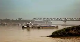 Ferries plying on the river with the bridge in the backdrop