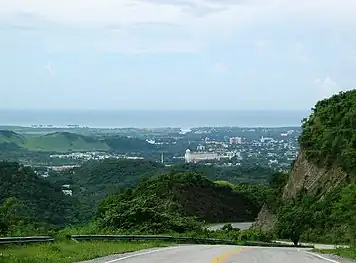 Puerto Rico Highway 139 (PR-139) in Barrio Maraguez, Ponce, heading south, with the City of Ponce and the Río Portugués channel in the background and the Caribbean Sea in the far background